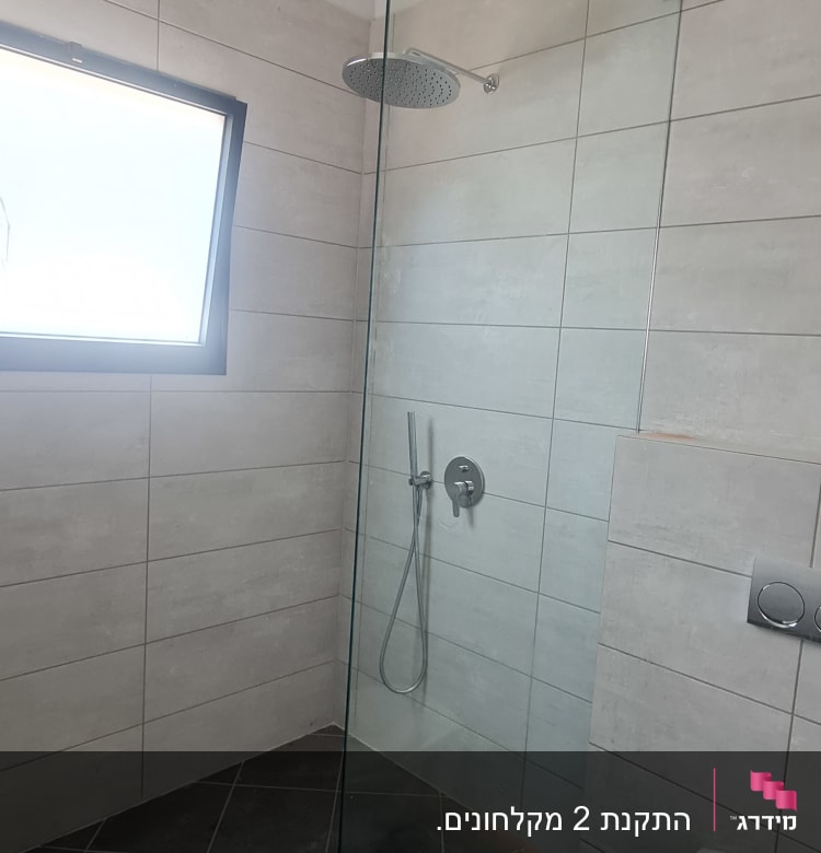 מקלחון זכוכית עם ראש מקלחת עגול וקיר אריחים